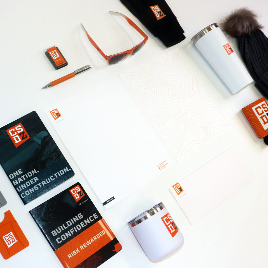 CSDZ promotional items including: phone wallet, pens, sunglasses and more