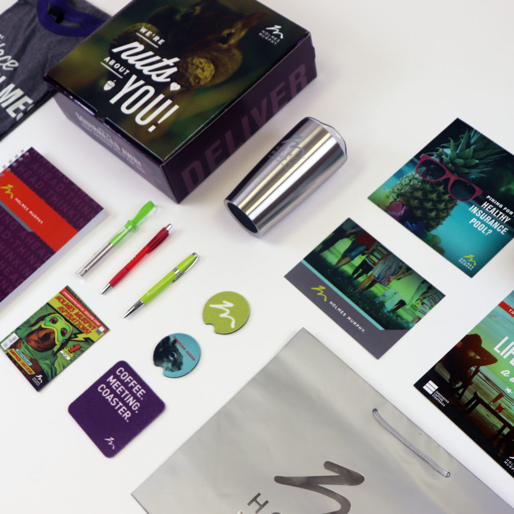 Holmes Murphy promotional items including: apparel, notebooks, pens, postcards and more
