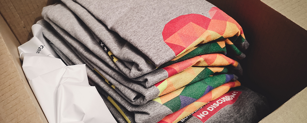 Stack of branded apparel shirts that have been screenprinted
